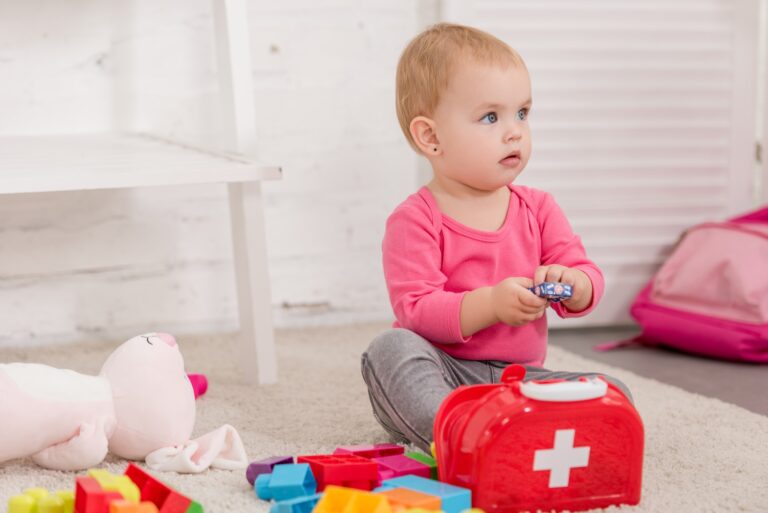 adorable child playing with first aid kit in children room