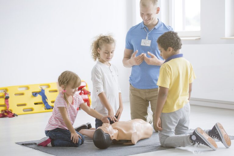 Kids practicing first aid steps