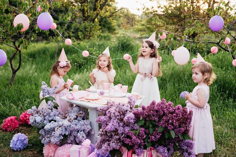 Summer outdoor kids birthday party. Group of happy Children celebrating birthday in park