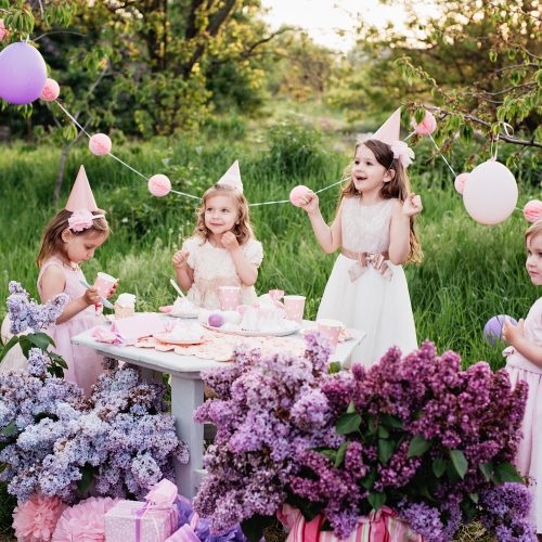 Summer outdoor kids birthday party. Group of happy Children celebrating birthday in park